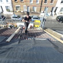 Adjusting the concrete tiles on this mansard conversion in Orbain Road - SW6