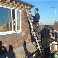 Aron of Ash Island Lofts tiling a dormer