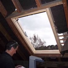 Velux window being fitted on loft conversion