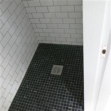 Wet room in loft conversion in Chiswick W4 by Ash Island Lofts with floor to ceiling tiles