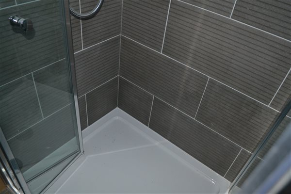 Shower room tiled in Ealing W13