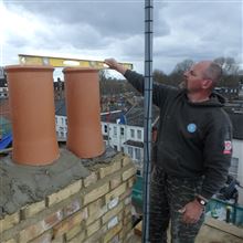 John in Harwood Road checking the Spirit Levels for the New Chimney - Fulham